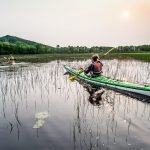 Kayakers paddling as the sunsets on the St. Louis River