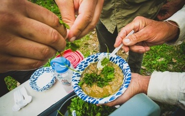 Curry in a paper bowl topped with cilantro