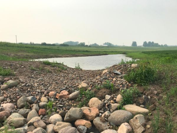 A small pond with rocks in the foreground